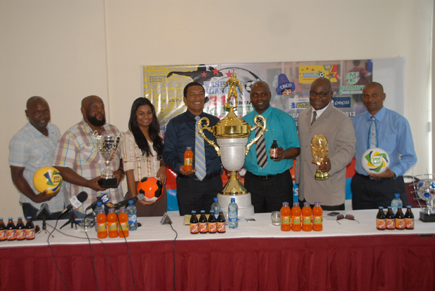 From left, Mark Younge, Desmond Helwig (Operations Manager Mohammed’s Enterprise), Darshanie Yusuf, Kashif Muhammad, Aubrey ‘Shanghai’ Major, Olata Sam and Roy McArthur strike a pose with trophies and samples of Smalta and Tropical Rhythm, following the launch yesterday. (Photo by Sonell Nelson)