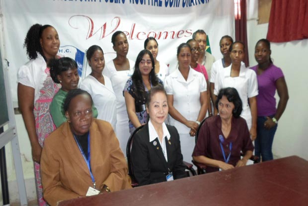 Posing with graduating nurses: At front and centre is Japanese Volunteer Ms. Yoshida SUM KO, flanked by Matron Audrey Corry and Sister Noshella Lalckecharran. Standing at rear right is GPHC CEO, Mr. Michael Khan.