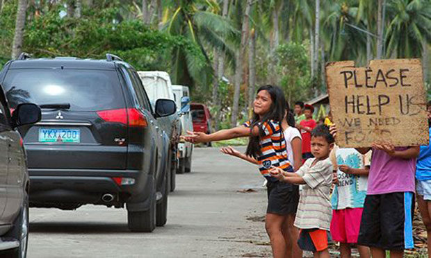 Children begging for food from passing motorists in Cebu, a region devastated by typhoon Haiyan (Photo courtesy of Jay Rommel Labra/EPA)