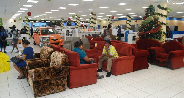 Customers sit and test out the brand new items which arrived at the store early yesterday morning