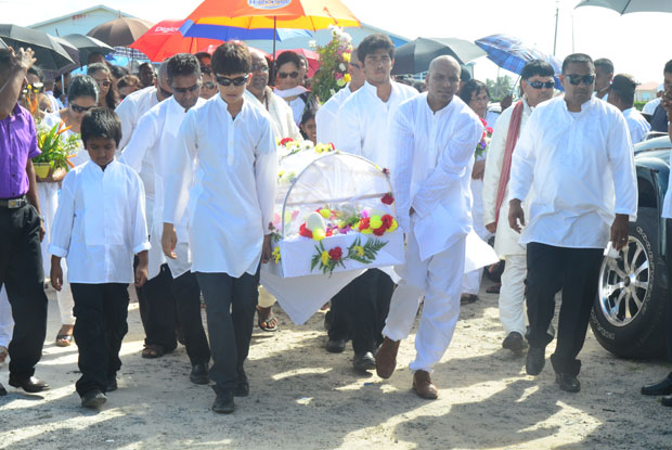 The body of Mrs Anoopwattie Veeren being carried to the crematorium site at Good Hope yesterday.