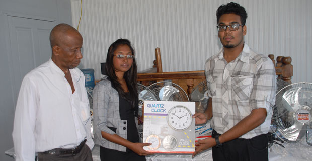 Buddy’s Group of Companies Marketing Manager Melisa Dharry presents the equipment to UGLS President Saeed Hamid and Head of the Law Department, Mr. Sheldon McDonald.