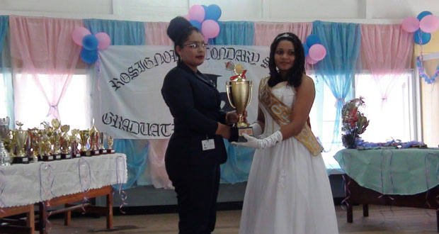 Mrs. Bibi F. Alli, Administrative Assistant at BBCI handing over a trophy last Friday to Rosignol Secondary School for their Best Graduating Student 2013.