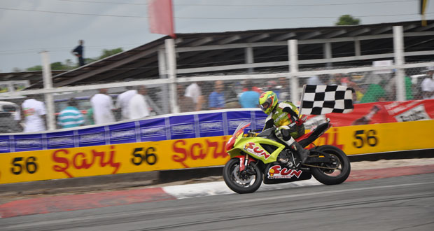 Stephen Vieira  with the chequered flag after  his victory.