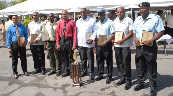 The best cops of the various divisions pose with Deputy Commissioner of Police Seelall Persaud, with their cash and plaques in hand