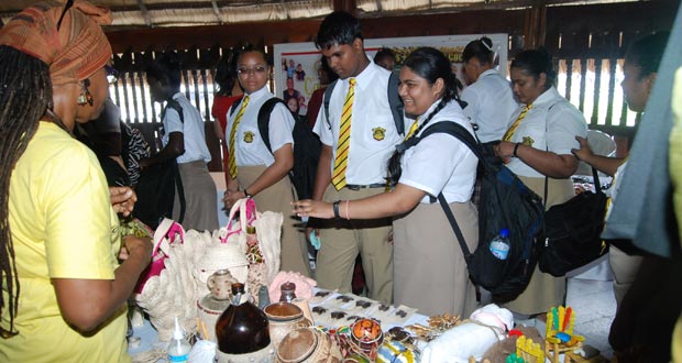Queen’s College students view some of the local craft made of coconut shells and wooden clothes pegs