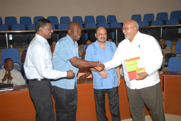 President Donald Ramotar, holding a copy of the ‘Health Vision 2020 National Strategy’ which he received from Health Minister Dr. Bheri Ramsaran (second right). Also in photo are Chief Medical Officer Dr. Shamadeo Persaud (left) and Permanent Secretary, Ministry of Health Mr. Leslie Codogan (second left).
