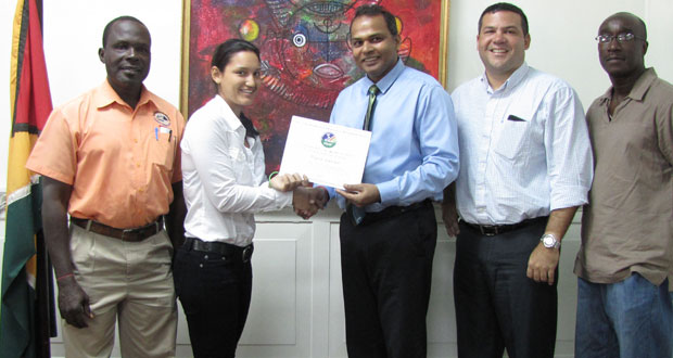 Alysa Xavier (second left) accepts the Pan American Hockey Federation certificate from Minister of Sport Dr Frank Anthony, while the others in picture, from left, GOA representative Deion Nurse, GHB president Philip Fernandes and GHB vice-president Ivor Thompson look on.
