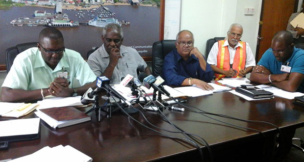 Minister Robeson Benn is flanked by senior officers of the Ministry of Public Works