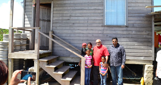 President Donald Ramotar and Minister of Housing and Water, Mr Irfaan Ali with one of the many beneficiaries of Saturday’s exercise