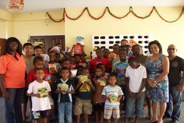 The grateful recepients as they posed with their gifts amongst members of the Kitty Bible Fellowship Church
