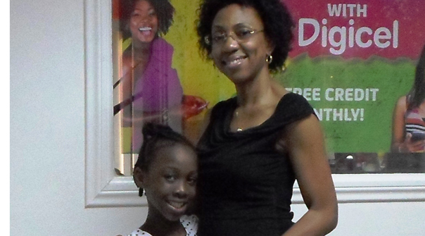 Terriann Wright in embrace with Digicel Guyana Head of Marketing, Jacqueline James on Monday.