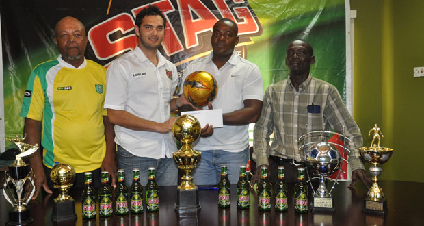 Stag Beer Brand Manager John Maikoo (second from left) hands over the sponsorship cheque to EBFA general secretary Franklyn Wilson at yesterday's League launch.