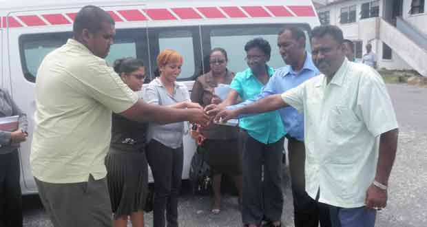 Region 2 Chairman Mr. Parmanand Persaud (right) and Dr Afarah Khan (second left) during the simple ceremony to hand over the keys to the Ambulance