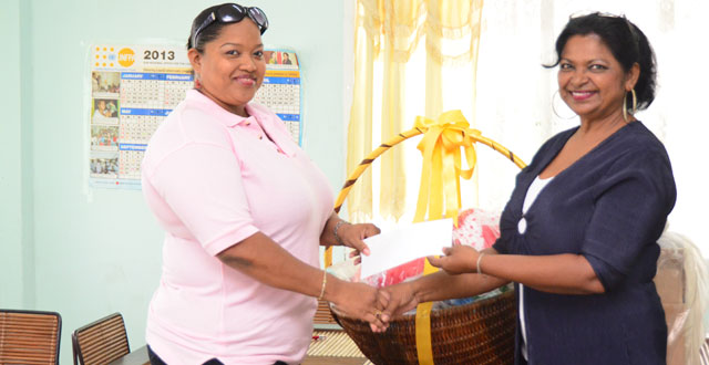 Isha Hussain- Singh, Director of Help & Shelter receiving the donation from President of the Inner Wheel Club of Georgetown, Aretha Campbell