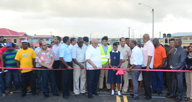 A student of the Hope Secondary School cuts the ribbon, officially opening the new bridge earlier this month