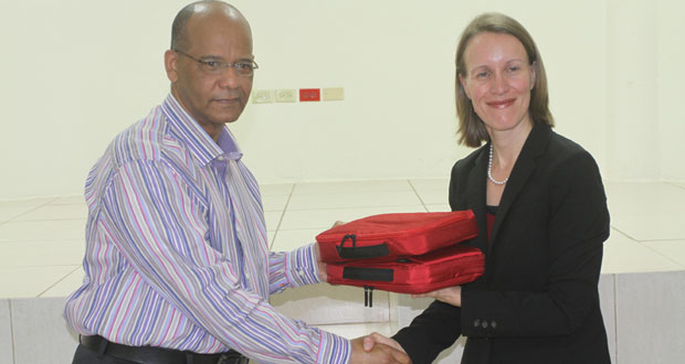 Canadian High Commissioner Dr. Nicole Giles presenting the fraudulent document detection kits to Home Affairs Minister Clement Rohee, yesterday. (Sonell Nelson photo)