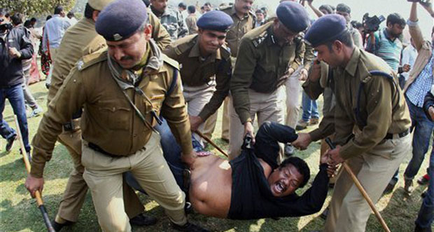 Indian policemen detain a supporter of the creation of a separate state of Telangana out of existing Andhra Pradesh state as he shouts slogans during a protest outside Vijay Chowk square in New Delhi, India, yesterday. (AP Photo)