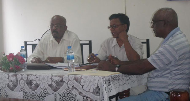Minister Norman Whittaker and other officials at the meeting