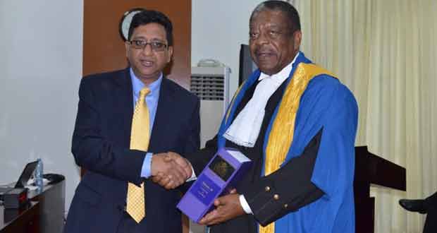 Attorney General and Minister of Legal Affairs Anil Nandlall officially handing over the country’s laws and law reports to President of the Caribbean Court of Justice Sir Charles Dennis Byron.
