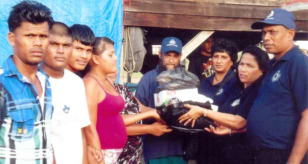 #65 CPG members presenting the donation of clothing, among other things, to relatives of the late Hubert Henry