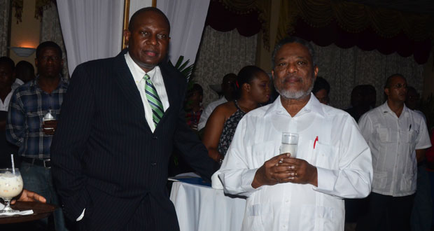 r Orlando Boxill, General Manager for SOL Guyana and Prime Minister Samuel Hinds having a chat