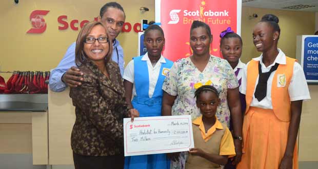 Doing the honours on behalf of ‘Scotia’ is Marketing Manager, Ms Jennifer Cipriani (left). With her are Habitat For Humanity Guyana’s Rawle Small, and Ms Boucher and her four daughters