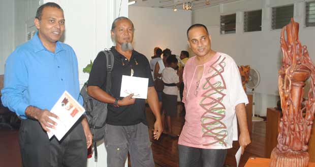 Minister of Culture, Youth and Sport, Dr. Frank Anthony with Artist Winslow Craig and Philbert Ghajadar at the exhibition
