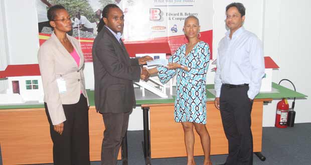 Habitat’s Mr Rawle Small receives the cheque from Mrs Anjuli Beharry in the presence of Beharry’s Chairman, Mr Anand Beharry (right) and a representative of Habitat for Humanity