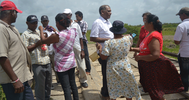 Agriculture Minister, Dr. Leslie Ramsammy engaging Mahaicony Creek residents during a visit there Wednesday.