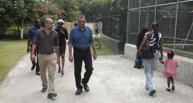 Minister Persaud (right) and Mr Fernandes taking a casual stroll around the Zoo yesterday