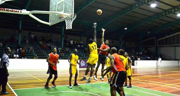 Ravens’ Akeem ‘the Dream’ Kanhai is airborne to score over Pacesetters’ Jermaine Hamilton during his side’s 61-58 point win last Sunday.