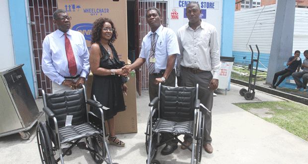 Mr. Owen John (centre right) receives the donated wheelchairs from Jacqueline Yhap (centre left). Also in photo are two other family members.