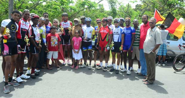 Prize winners of the various categories of the Dr Cheddi Jagan Memorial Cycle Road Race strike a pose for photographer Adrian Narine. Eighth (left) is Member of Parliament Bibi Shadick while at extreme right is Director of Sport Neil Kumar.
