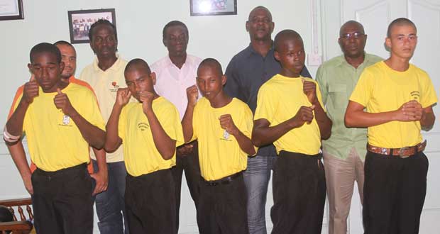 The five boxers, all decked out in their MCYS tops, are from left: Andrew Newton, Niko Jodha, Kalvin Barry, Joel Bess and Samuel Forde strike a pose while at the back from left Brandon Caboose, Lawrence Kellman, Wincell Thomas, Terrence Poole and Steve Ninvalle look on appreciatively. (Photo by Sonell Nelson)