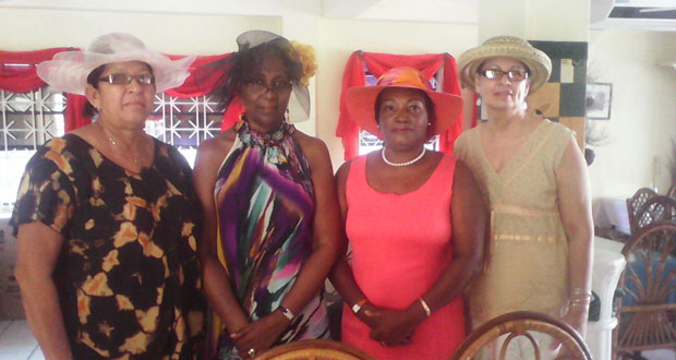 Representatives of the Inner Wheel Club of Georgetown pose with pieces of their Easter Hat Collection.