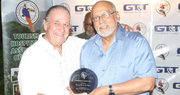 Mr Colin Edwards receives the THAG President’s Award for Rupununi Music & Arts Festival from President Ramotar