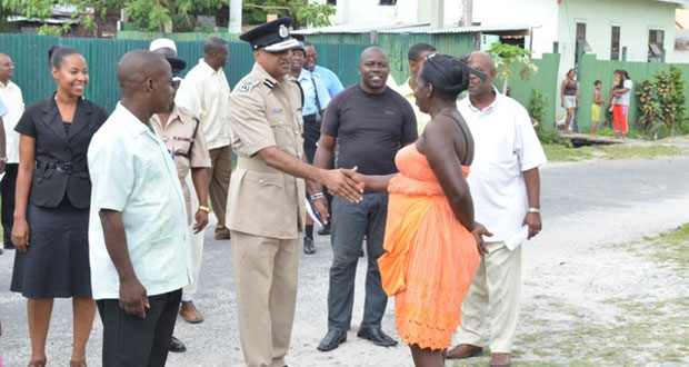 Commissioner of Police (Ag) Seelall Persaud, greeting a member of the Albouystown Community at the launch of the Albouystown Impact Project which was held at Independence Boulevard, Hunter Street, Albouystown