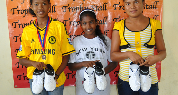 Recipients of the Mitseden soccer boots from right: Krista De Silva, Nikita Amardeo and Diana Angoy.