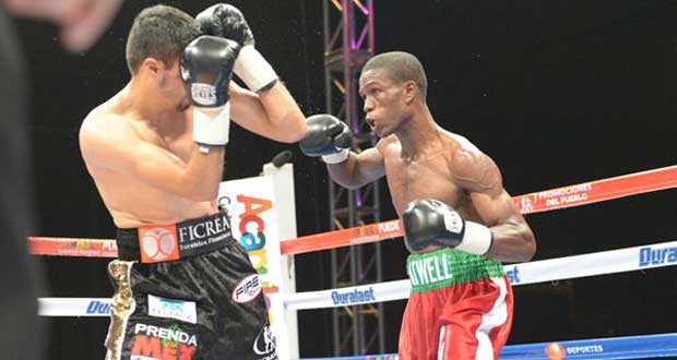 Guyana’s Clive Atwell prepares to land a left to the face of Mexico’s Jhonny Gonzalez during their WBC Featherweight World Title fight in Mexico.