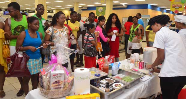 A crowd looks on keenly as one of the Carnegie students demonstrates how to make ice cream