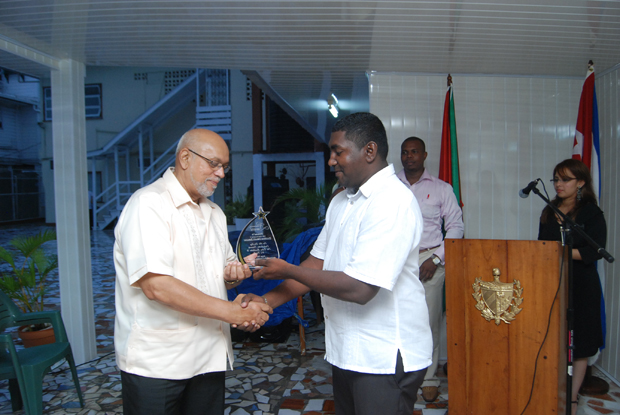 President Donald Ramotar is honoured by Chairman of the Guyana-Cuba Friendship Association, Howard Samaroo, for his long standing support of a Guyana-Cuba partnership