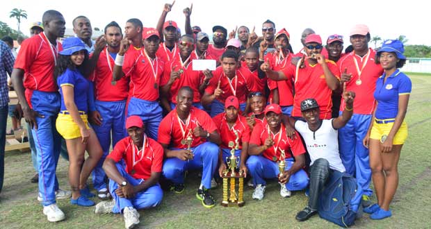 All hail the champions! The victorious Police Sports Club unit strike a pose with their spoils and the Carib Beer Girls, after defeating Georgetown Cricket Club in the final of the GCA/Carib Beer T20 first division tournament yesterday. (Photo by Adrian Narine)