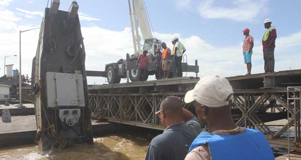 The crane successfully gets the tug out of the river