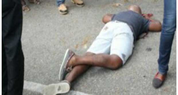 ‘SHOT DEAD’: The body of alleged teen bandit Lloyd Hazel lying on Main Street, Georgetown yesterday afternoon