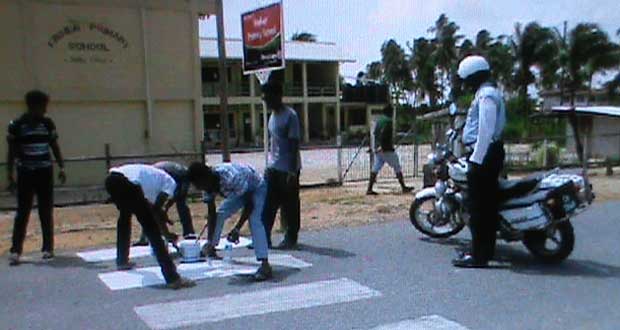 PYARG members paint the pedestrian crossing