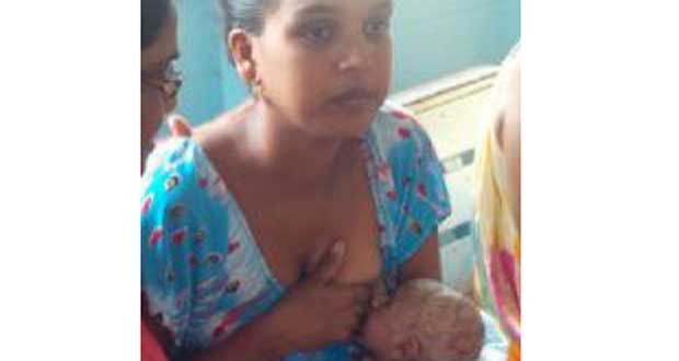 Sandra McLean and her new-born baby at the Whim Police Station (Photo courtesy of iNews Guyana)