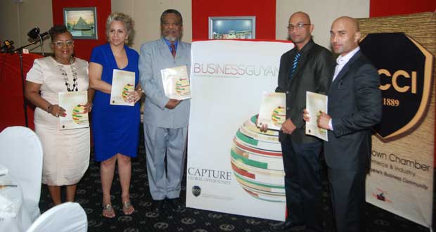 At the ‘Guyana Magazine’ launch at the Pegasus Hotel Friday. Displaying a magazine each are, from left, GCCI Chairperson, Dr. Dawn Stewart-Lyken; IDB Resident Representative, Ms. Sophie Maconnen; Prime Minister, Mr. Samuel Hinds; GCCI Secretary, Mr. Nicholas Boyer; and GCCI Senior Vice-Chairman, Mr. Vishnu Doerga (Photo by Cullen Bess-Nelson)