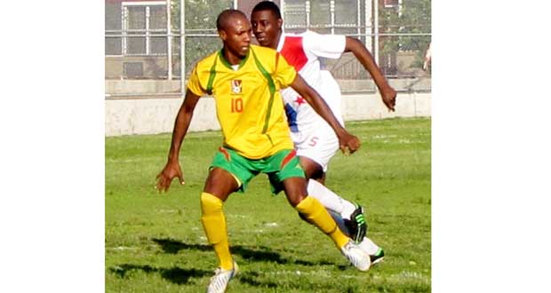 Anthony ‘Awo’ Abrams being closely marked by a Panamanian defender during their clash, as Guyana went on to win 8-1. (Photo compliments of www.caribbeancupsoccer.com)