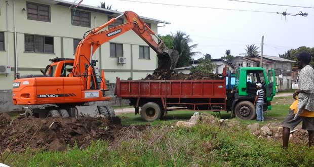 The Ministry of Public Works’ machinery loading dirt into the back of a truck for dumping